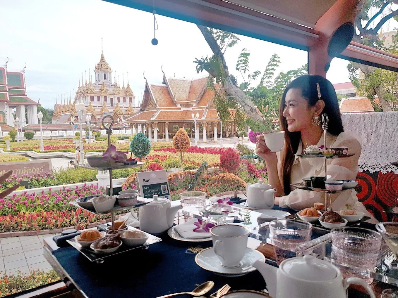 Afternoon tea on board the Thai Bus Food Tour with a view of a Bangkok temple