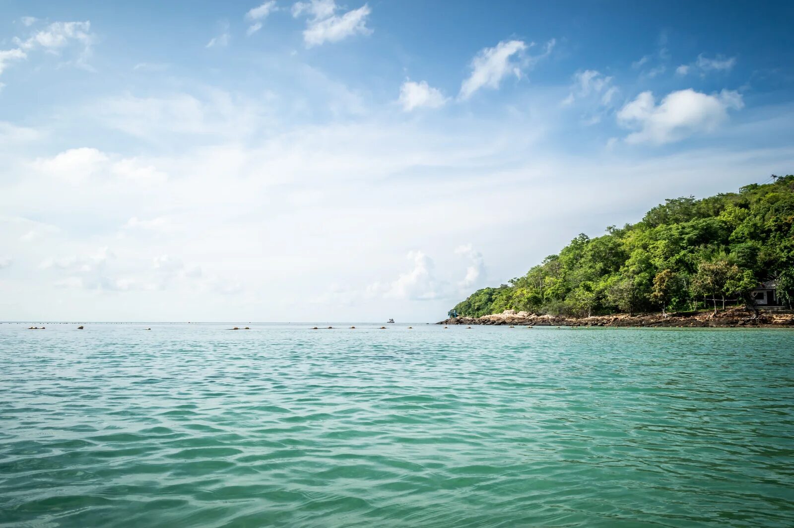 The clear sea and green coastline of Koh Samet