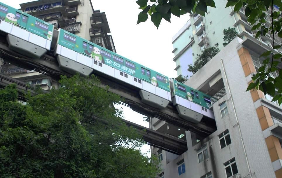 Chongqing monorail train passing through a residential block at Liziba Station