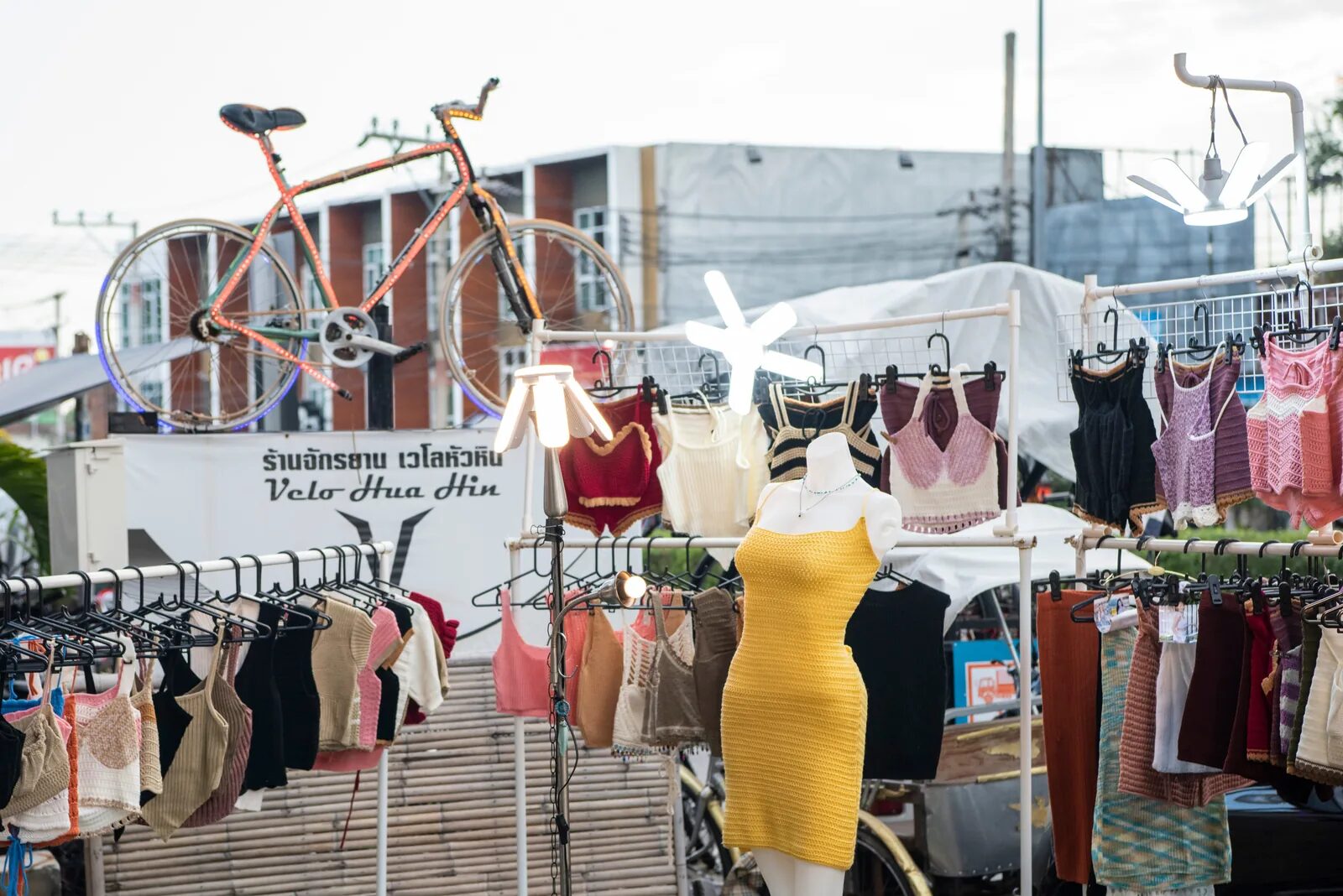 Clothing stalls on both sides of the tracks at the Maeklong Railway Market