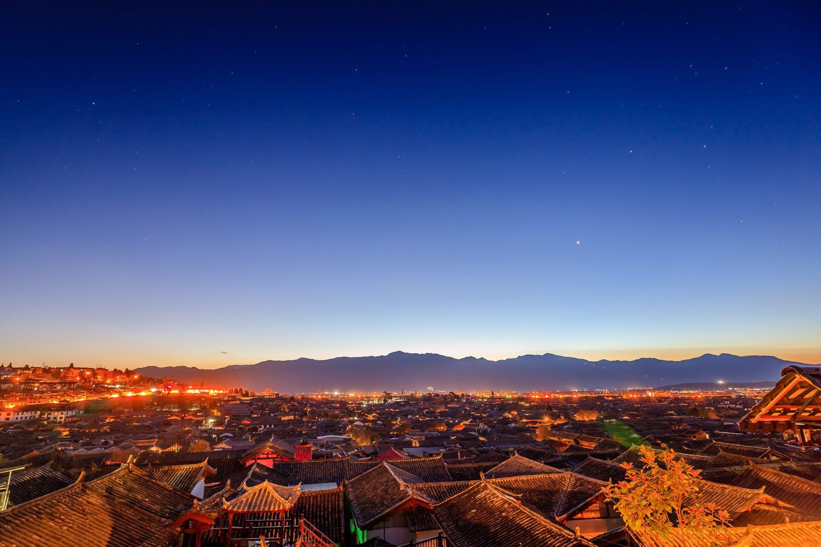 Rolling tiled roofs of Lijiang Old Town at night