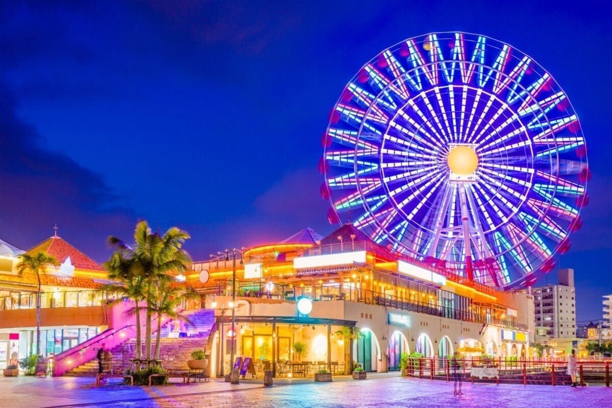 Ferris wheel and evening shopping streets at American Village, Chatan