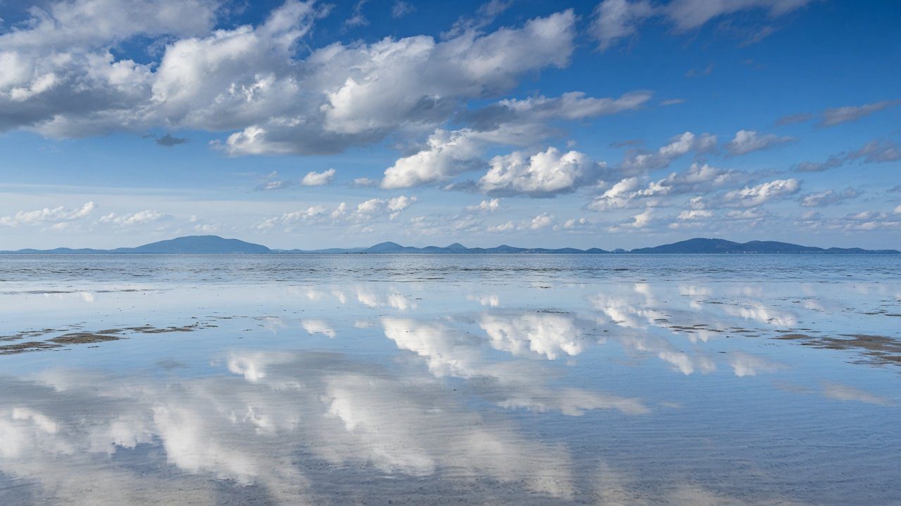 Mirror-like reflections on the tidal flats of Chichibugahama Beach