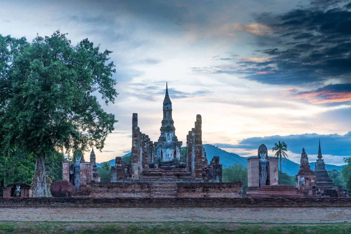 Ancient Buddha statue and temple ruins in Sukhothai Historical Park