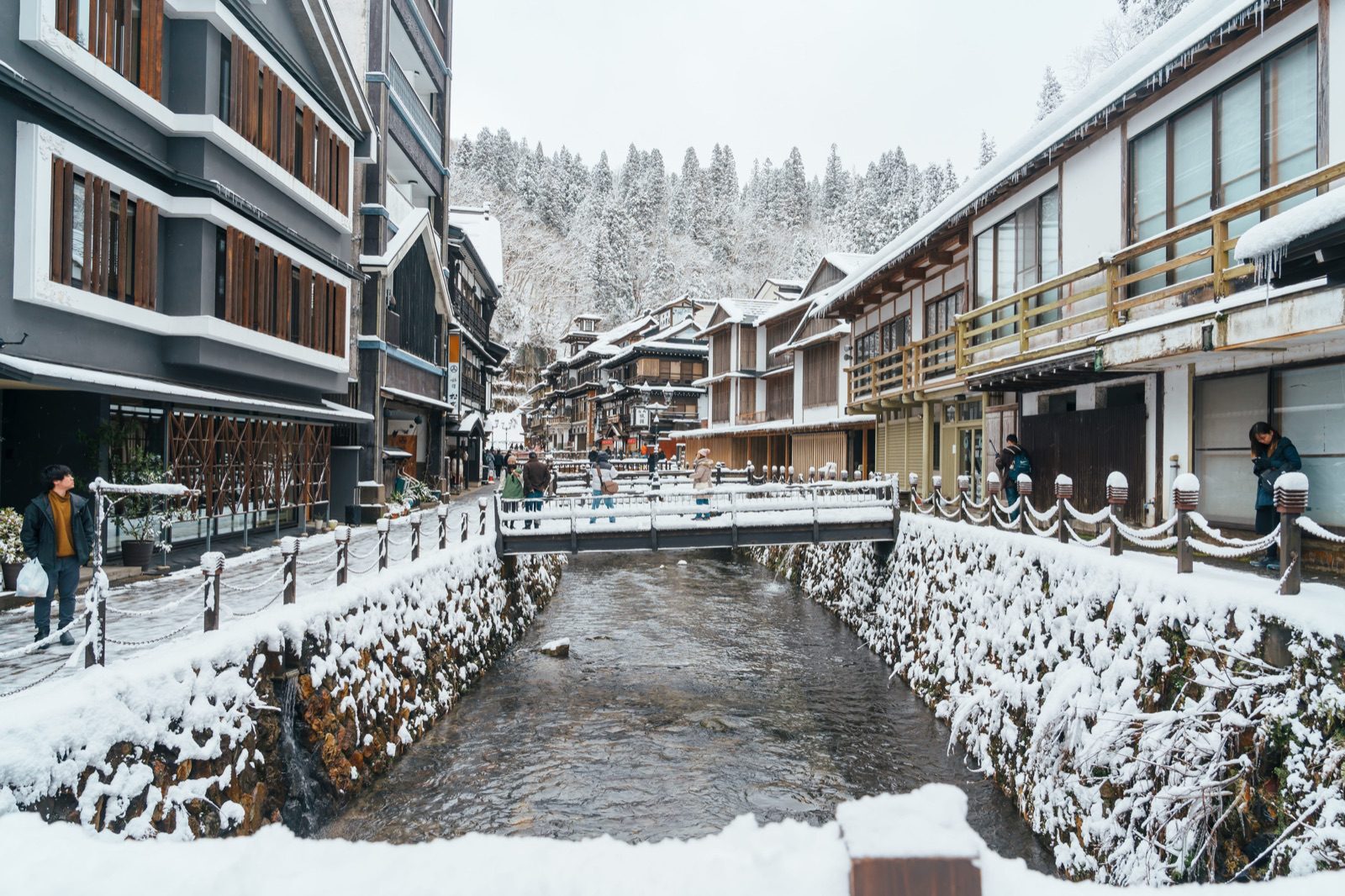 Snow-covered riverbanks and wooden inns of Ginzan Onsen